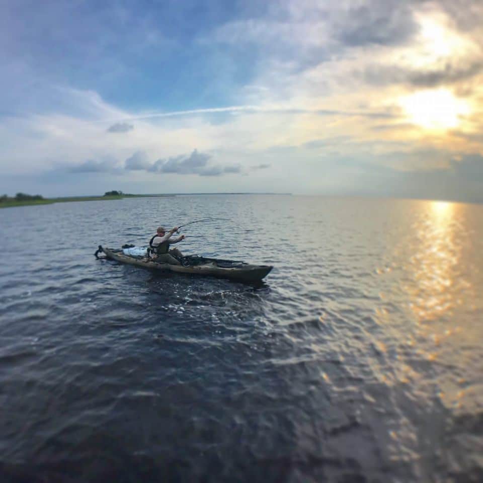 a picture of a kayaker fighting a redfish on a crystal river kayak fishing charter