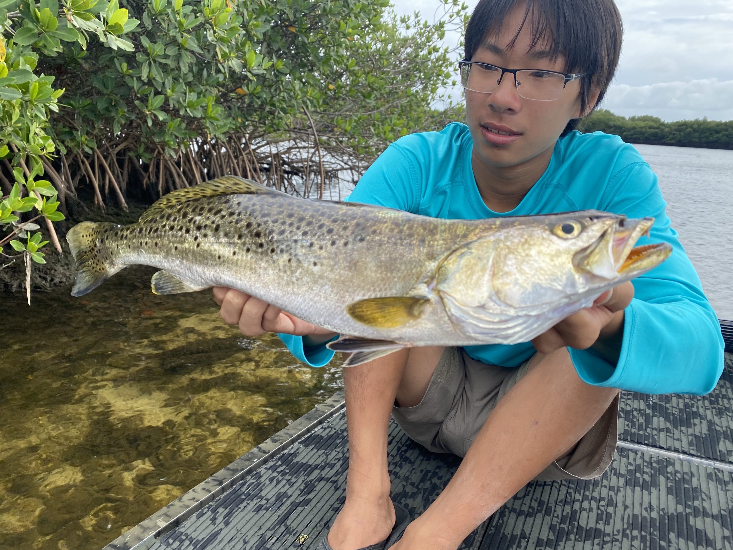 a fisherman holding a good sized seatrout while on a crystal river fishing charter