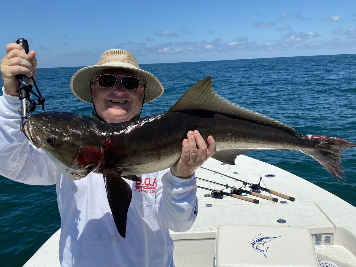 a picture of a client who is on a crystal river fishing charter holding a cobia they caught