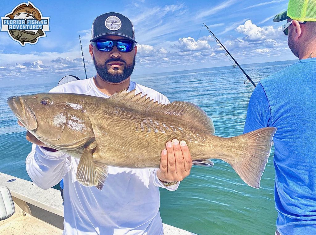 a fisherman with a grouper