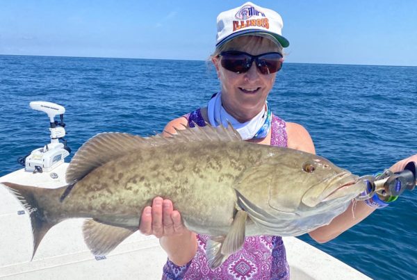 a fisherman with a grouper