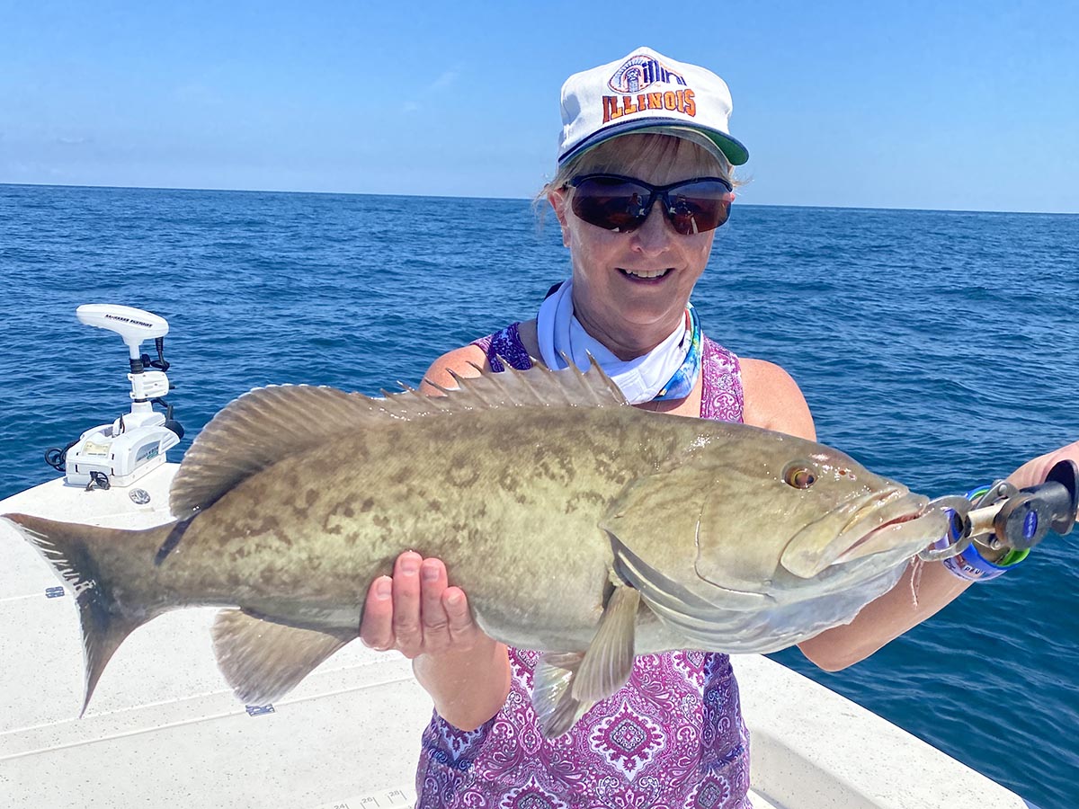 a fisherman with a grouper