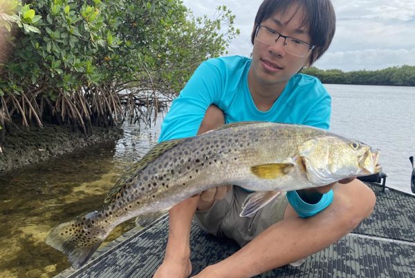 A crystal river fishing charter client holding a seatrout