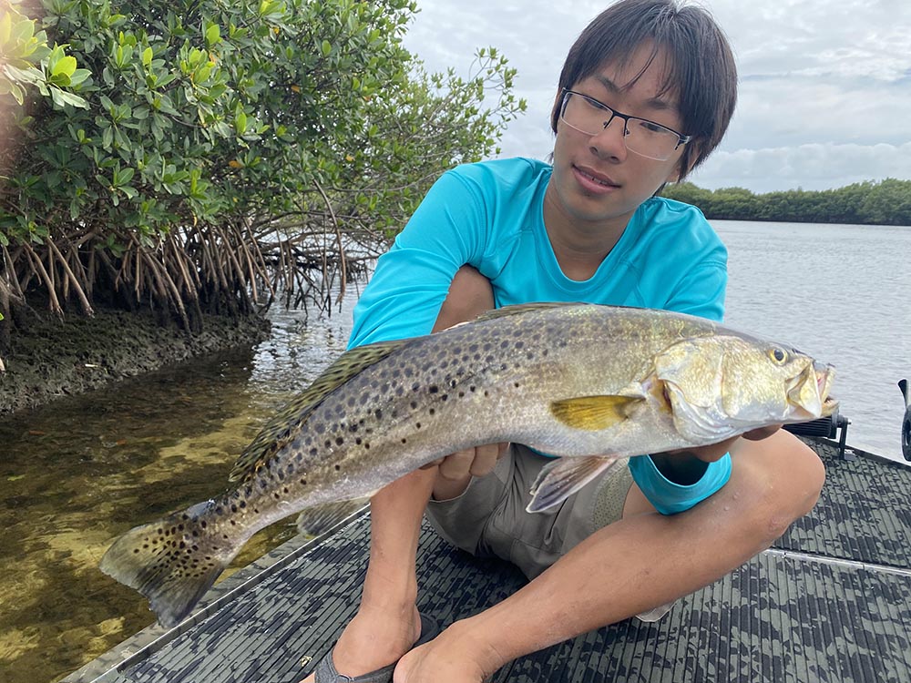 A crystal river fishing charter client holding a seatrout