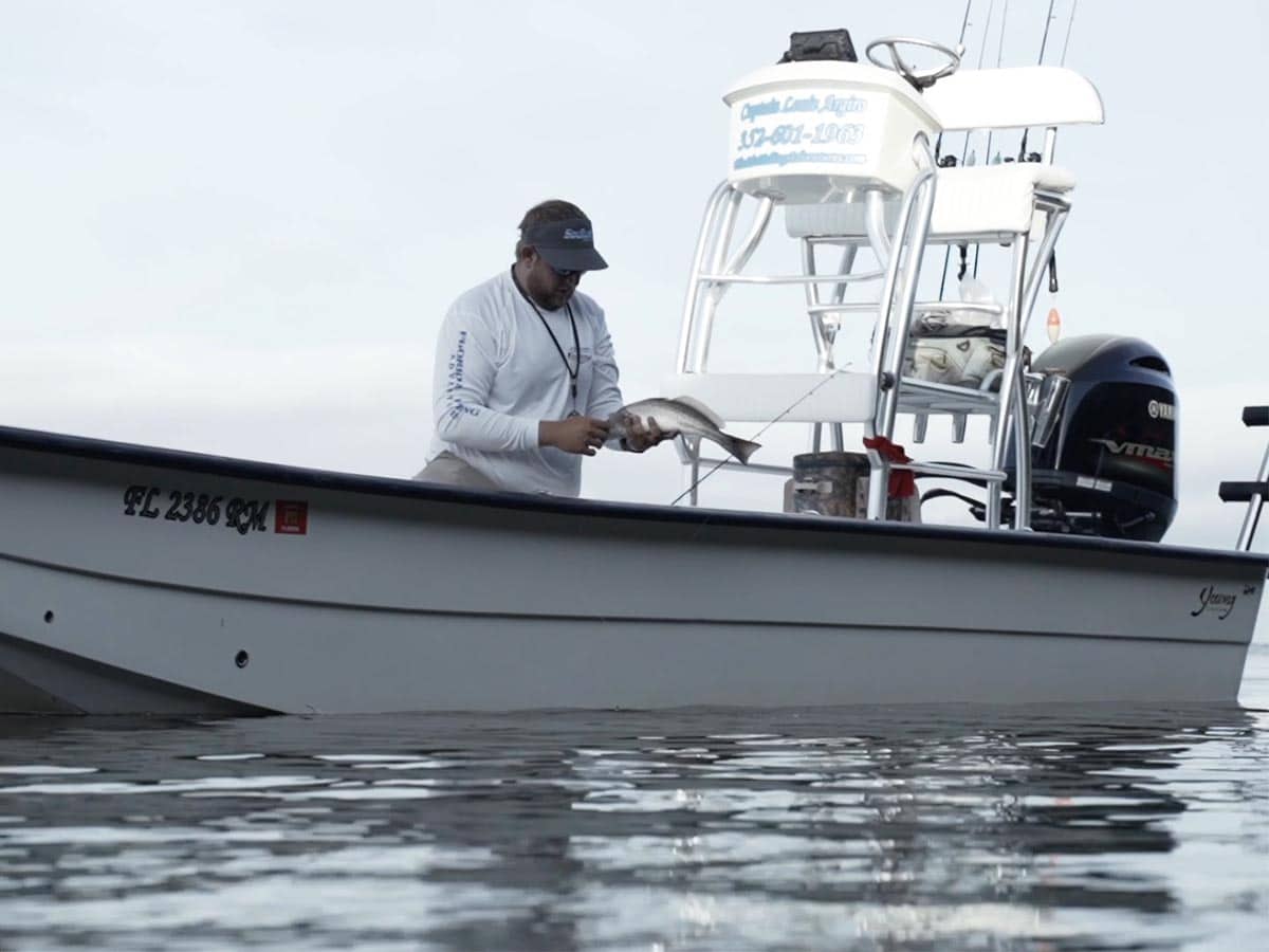 My Boats a picture of a fisherman and their boat holding a redfish they caught on a crystal river fishing trip
